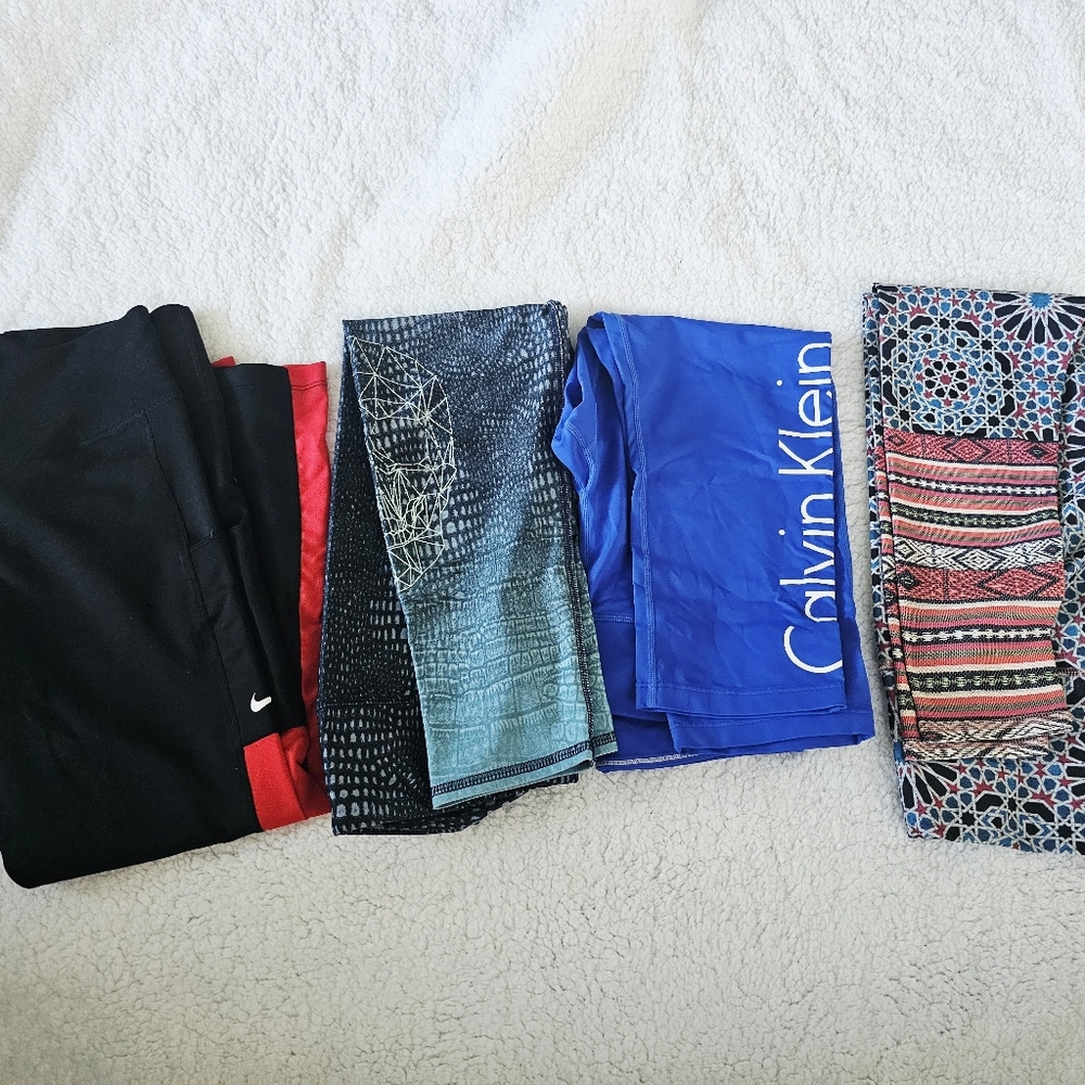 Four Pairs Of Womens Leggings. Medium Nike, Calvin Klein, Skullhead, and Pattern